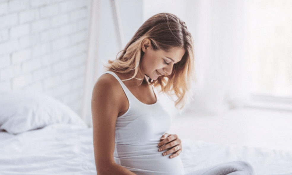 pregnant woman holding stomach