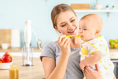 A mom feeding her baby