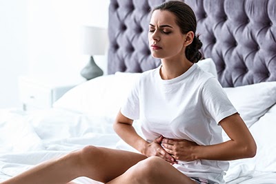 Young pregnant woman suffering from lower belly aches