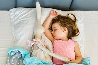 Small child sleeping on a pillow