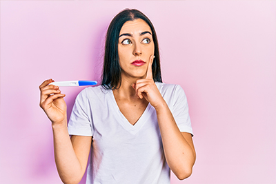 woman holding pregnancy test