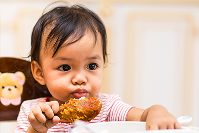 One year old baby eating meat