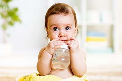 Baby drinking water from a bottle