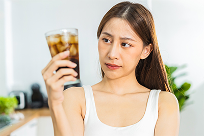 woman looking at soda